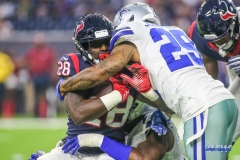 HOUSTON, TX - AUGUST 30: Houston Texans running back Alfred Blue (28) is tackled by Dallas Cowboys defensive back Jeron Johnson (29) during the preseason game between the Houston Texans and Dallas Cowboys on August 30, 2018, at NRG Stadium in Houston, TX. (Photo by George Walker/DFWsportsonline)