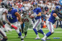 HOUSTON, TX - SEPTEMBER 23: Houston Texans defensive end J.J. Watt (99) forces a fumble by New York Giants quarterback Eli Manning (10) during the game between the Houston Texans and New York Giants on September 23, 2018, at NRG Stadium in Houston, TX. (Photo by George Walker/DFWsportsonline)