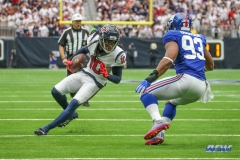 HOUSTON, TX - SEPTEMBER 23: Houston Texans wide receiver DeAndre Hopkins (10) tries to avoid a tackle by New York Giants linebacker B.J. Goodson (93) during the game between the Houston Texans and New York Giants on September 23, 2018, at NRG Stadium in Houston, TX. (Photo by George Walker/DFWsportsonline)