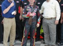 Jeff Gordon is presented a Berretta shotgun after winning the pole for the 2009 Dickies 500 at Texas Motor Speedway. Photo by George Walker.