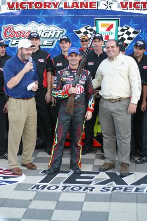 Jeff Gordon is presented a Berretta shotgun after winning the pole for the 2009 Dickies 500 at Texas Motor Speedway. Photo by George Walker.