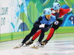 VANCOUVER, BC - FEBRUARY 24: Jordan Malone of the United States and Peter Darazs of Hungary compete in the Short Track Speed Skating Men's 500m heat on day 13 of the 2010 Vancouver Winter Olympics at Pacific Coliseum on February 24, 2010 in Vancouver, Canada. (Photo by Jamie Squire/Getty Images)