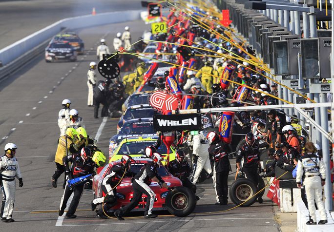 Crews complete a pit stop during the NASCAR 5-hour Energy 250 at Gateway International Raceway. Credit: John Sommers II/Getty Images for NASCAR