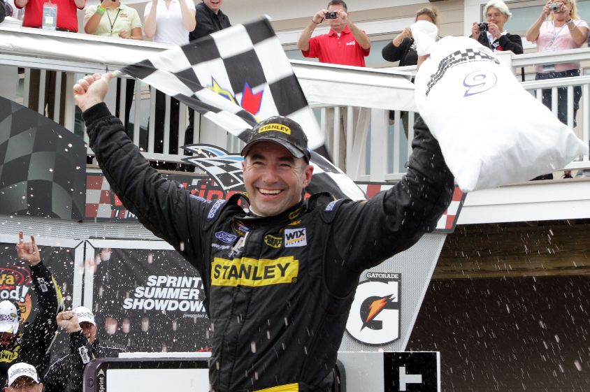 Marcos Ambrose, driver of the No. 9 Stanley Ford, celebrates in Victory Lane after winning the NASCAR Sprint Cup Series Heluva Good! Sour Cream Dips at the Glen at Watkins Glen International on Aug. 15 in Watkins Glen, N.Y. Credit: Jerry Markland/Getty Images for NASCAR