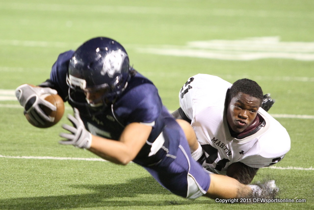 Arlington Martin's Steven Amoako loses his helmet as he tackles Flower Mound's Brad Bush. Photo by George Walker for DFWsportsonline